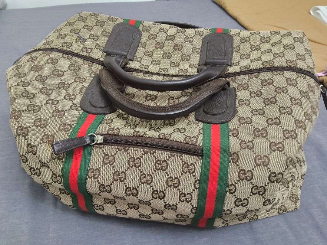 Gucci Boston Bag (Category: Luxury Bags & Wallets) located in Mandaluyong City. Submitted by epicowl-c93c (Listing ID 1421580773, Image 1). Description: - not guaranted authentic Gucci Boston Bag - Iconic GG monogram pattern - Brown leather handle - Red and green stripe detail - Secure zipper closure - Convenient front pocket - Ideal for travel or as a large handbag.