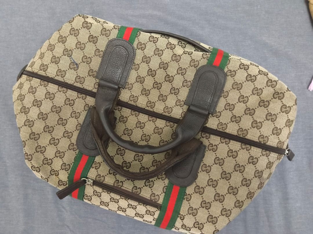 Gucci Boston Bag (Category: Luxury Bags & Wallets) located in Mandaluyong City. Submitted by epicowl-c93c (Listing ID 1421580773, Image 2). Description: - not guaranted authentic Gucci Boston Bag - Iconic GG monogram pattern - Brown leather handle - Red and green stripe detail - Secure zipper closure - Convenient front pocket - Ideal for travel or as a large handbag.