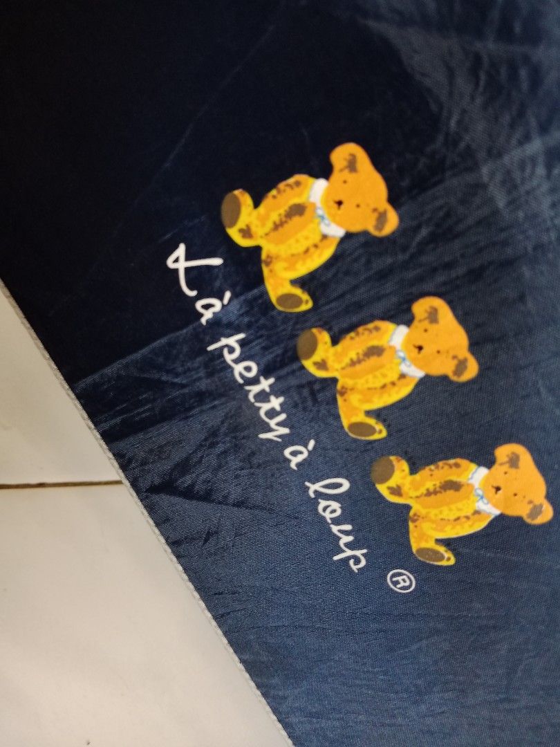 La petty a loup Umbrella (Category: Umbrellas) located in Polangui. Submitted by cornerbags_shoes (Listing ID 1421548514, Image 2). Description: Japan surplus - Navy blue La petty a loup umbrella - Features a cute teddy bear design - Silver interior - Black handle - Folds up compactly - Perfect for rainy days - Stylish and functional - not automatic.