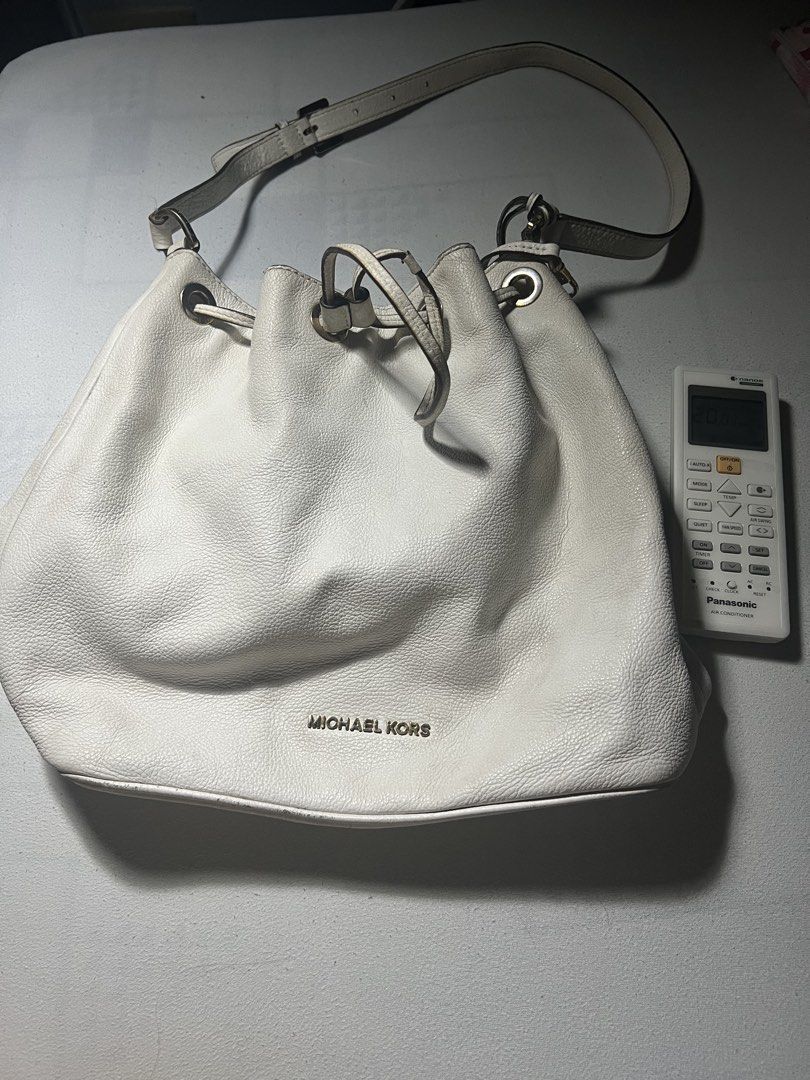 Michael Kors White Bucket Bag (Category: Luxury Bags & Wallets) located in Cavite. Submitted by xyrene_21 (Listing ID 1421574652, Image 2). Description: - White Michael Kors bucket bag - Drawstring closure - Shoulder strap - Michael Kors logo on front - Made of leather - Silver-tone hardware - Spacious interior.