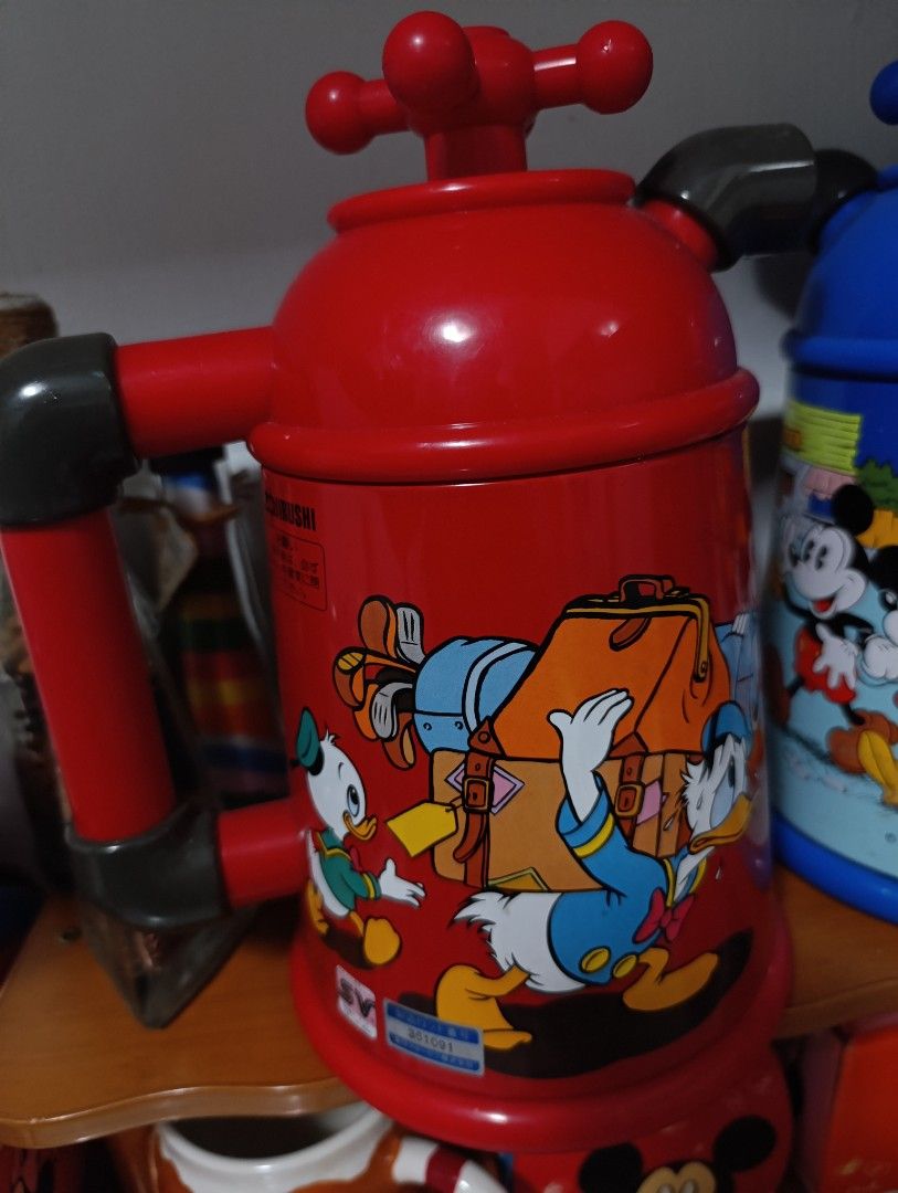 Mickey Mouse Thermos (Category: Pitchers & Dispensers) located in Caloocan City. Submitted by ira_28 (Listing ID 1421461313, Image 2). Description: Mickey Mouse Thermos - Features iconic Disney characters - Red body with a convenient handle - Tap-like design on top - Colorful design featuring Donald Duck and friends - Perfect collectible for Disney enthusiasts.