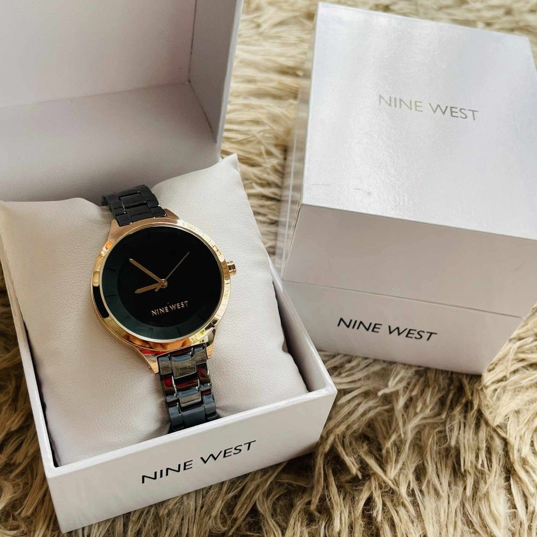 Nine West Black and Gold Watch (Category: Women's Watches) located in Victoria. Submitted by reignf027 (Listing ID 1421549345, Image 1). Description: - Nine West watch - Black dial with gold-tone hands and markers - Gold-tone bezel - Dark grey metal strap - Comes with original box - Suitable for everyday wear or special events.