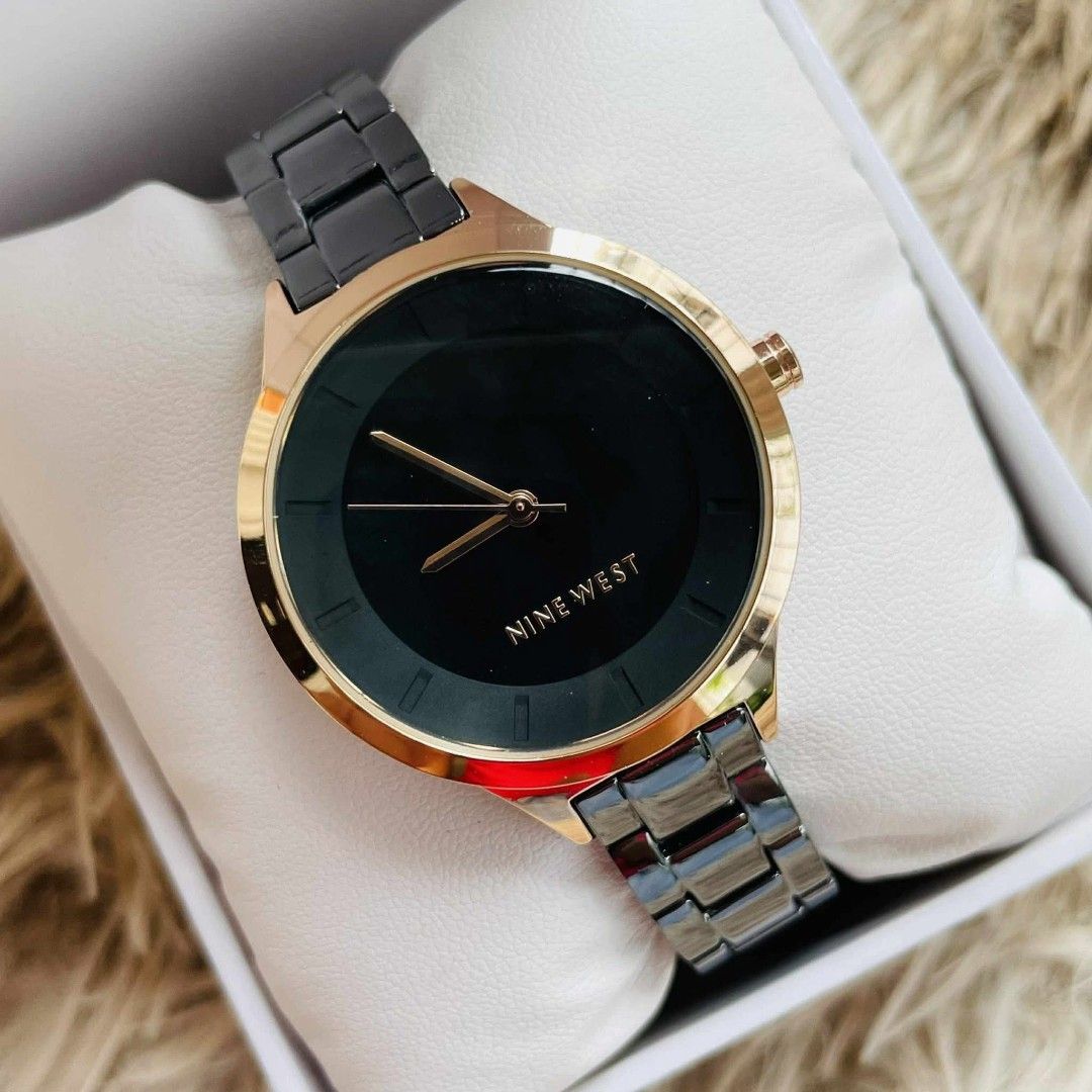 Nine West Black and Gold Watch (Category: Women's Watches) located in Victoria. Submitted by reignf027 (Listing ID 1421549345, Image 2). Description: - Nine West watch - Black dial with gold-tone hands and markers - Gold-tone bezel - Dark grey metal strap - Comes with original box - Suitable for everyday wear or special events.