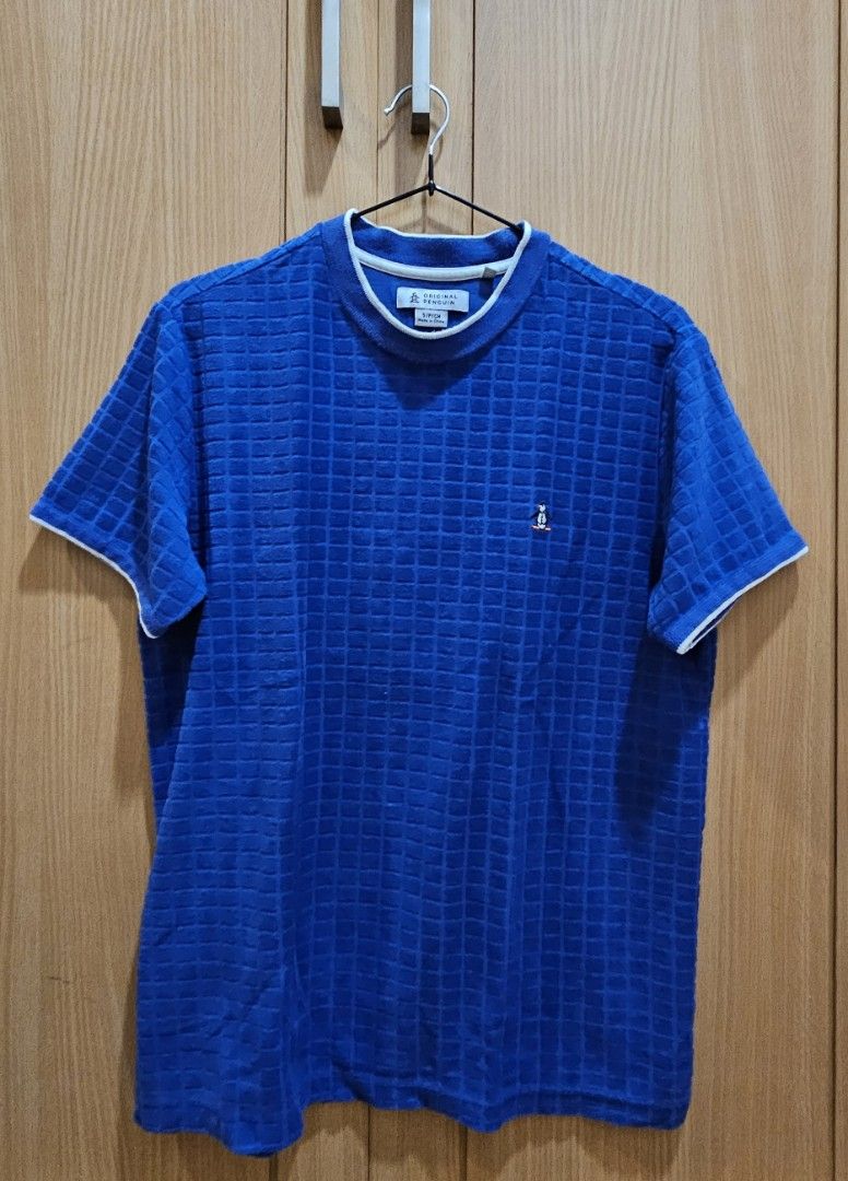 Original Penguin Blue Textured T-shirt (Category: Tshirts & Polo Shirts ) located in Quezon City. Submitted by ricac. (Listing ID 1421542010, Image 3). Description: - Original Penguin t-shirt - Color: Blue - Texture: Unique square pattern - Features: Penguin logo on chest, white trim on crew neck - Size: S/P/CH - Made in China.