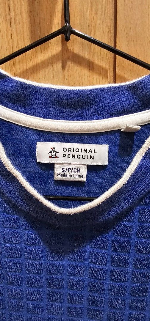 Original Penguin Blue Textured T-shirt (Category: Tshirts & Polo Shirts ) located in Quezon City. Submitted by ricac. (Listing ID 1421542010, Image 2). Description: - Original Penguin t-shirt - Color: Blue - Texture: Unique square pattern - Features: Penguin logo on chest, white trim on crew neck - Size: S/P/CH - Made in China.