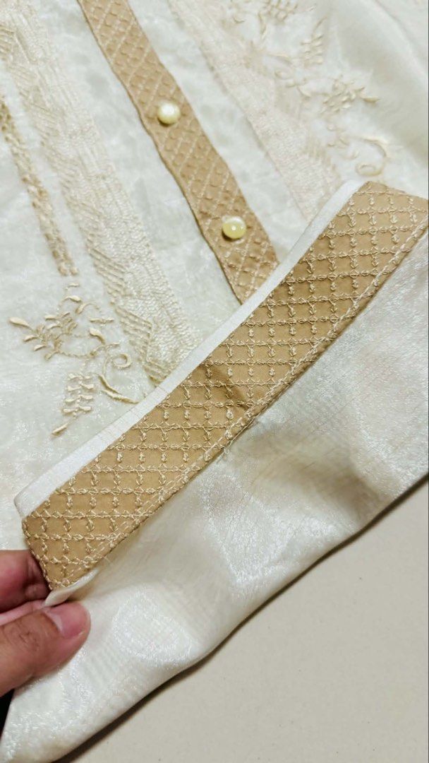 Pinya Barong Tagalog with Embroidery (Category: Formal Shirts) located in Rizal. Submitted by gen_maturan30 (Listing ID 1421594153, Image 3). Description: - Cream-colored Barong Tagalog - Intricate embroidery - Chinese collar - Long sleeves with buttoned cuffs - Decorative front panel with buttons - Subtle sheen fabric - Measurements: 30" length, 23.5" width USED ONCE RFS: Decluttering.