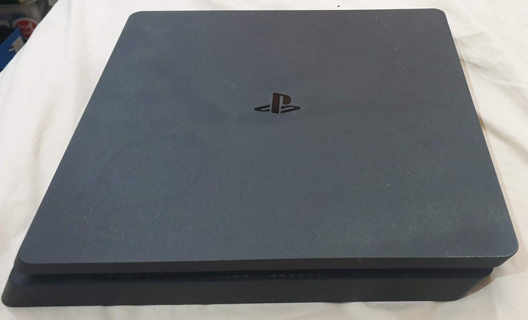 PlayStation 4 Console with Games and Accessories (Category: PlayStation) located in Paranaque City. Submitted by tnfonlineshop (Listing ID 1421499872, Image 1). Description: - PlayStation 4 console - Two controllers: blue camo and pink - PlayStation camera - Five games: - Watch Dogs Complete Edition - Terraria - The Division - Call of Duty Black Ops III - Lego Avengers - Carrying case for controllers and accessories - Power cable included.