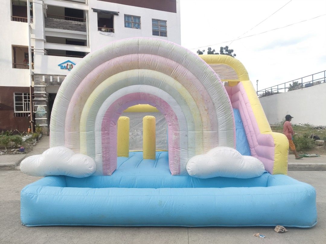 Rainbow Inflatable Bouncer with Slide (Category: Infant Playtime) located in Manila. Submitted by prettyme101395 (Listing ID 1421595372, Image 1). Description: Used once nung bday lng ng anak ko kaso nag ka molds nung tinabi namin paparent sana namin kso nag kron ng molds then nagamitan ng matapang na Molds remover kya nag fade ung rainbow lng nmn na design WALANG BUTAS O ANY DAMAGE MAKAPAL ITO ONCE LNG NAGAMIT THIS IS PVC MATERIAL NOT OXFORD NA 