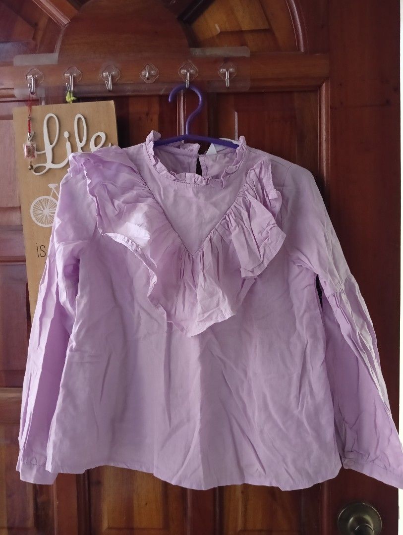 Redtag Girls Blouse (Category: Babies & Kids Fashion) located in Santa Rosa. Submitted by amiraamara (Listing ID 1421526973, Image 1). Description: - Redtag lavender blouse - For girls aged 7-8 - Ruffled design - Long sleeves - Round neckline - Simple and elegant style - Perfect for everyday or special occasions.