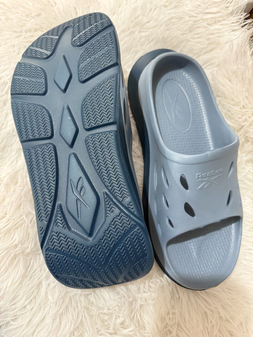 Reebok Slides (Category: Slippers & Slides) located in Cavite. Submitted by 0825cherry (Listing ID 1421473022, Image 2). Description: - Light blue Reebok slides - Reebok logo detail - Textured footbed for comfort - Durable outsole - Breathable design with cut-out details - Ideal for casual wear and post-workout recovery.