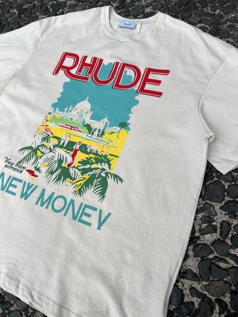 Rhude New Money Graphic Tee (Category: Tshirts & Polo Shirts ) located in Manila. Submitted by -handpick- (Listing ID 1421511591, Image 2). Description: - Rhude "New Money" graphic tee - Color: Cream - Made in USA - Features: Crew neck, short sleeves Size: Large Dimensions : Length: 30 Width: 24 Shoulder : 23 Sleeve : 9 Issue : Check last pic..