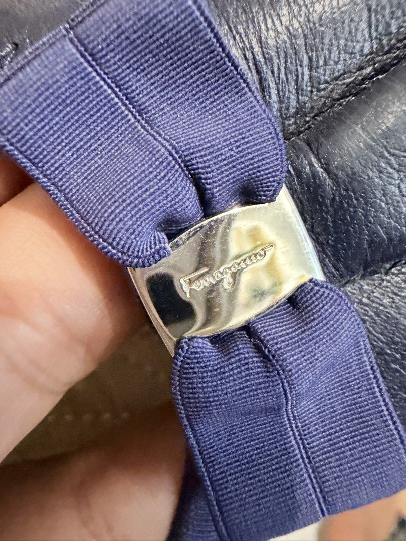 Salvatore Ferragamo Navy Blue Flats (Category: Flats & Sandals) located in Laoac. Submitted by radsjac (Listing ID 1421517245, Image 2). Description: - Salvatore Ferragamo flats - Color: Navy blue - Features bow detail with brand logo - Interior with Ferragamo logo - Rounded toe design - Material: Leather - Sole color: Light tan.