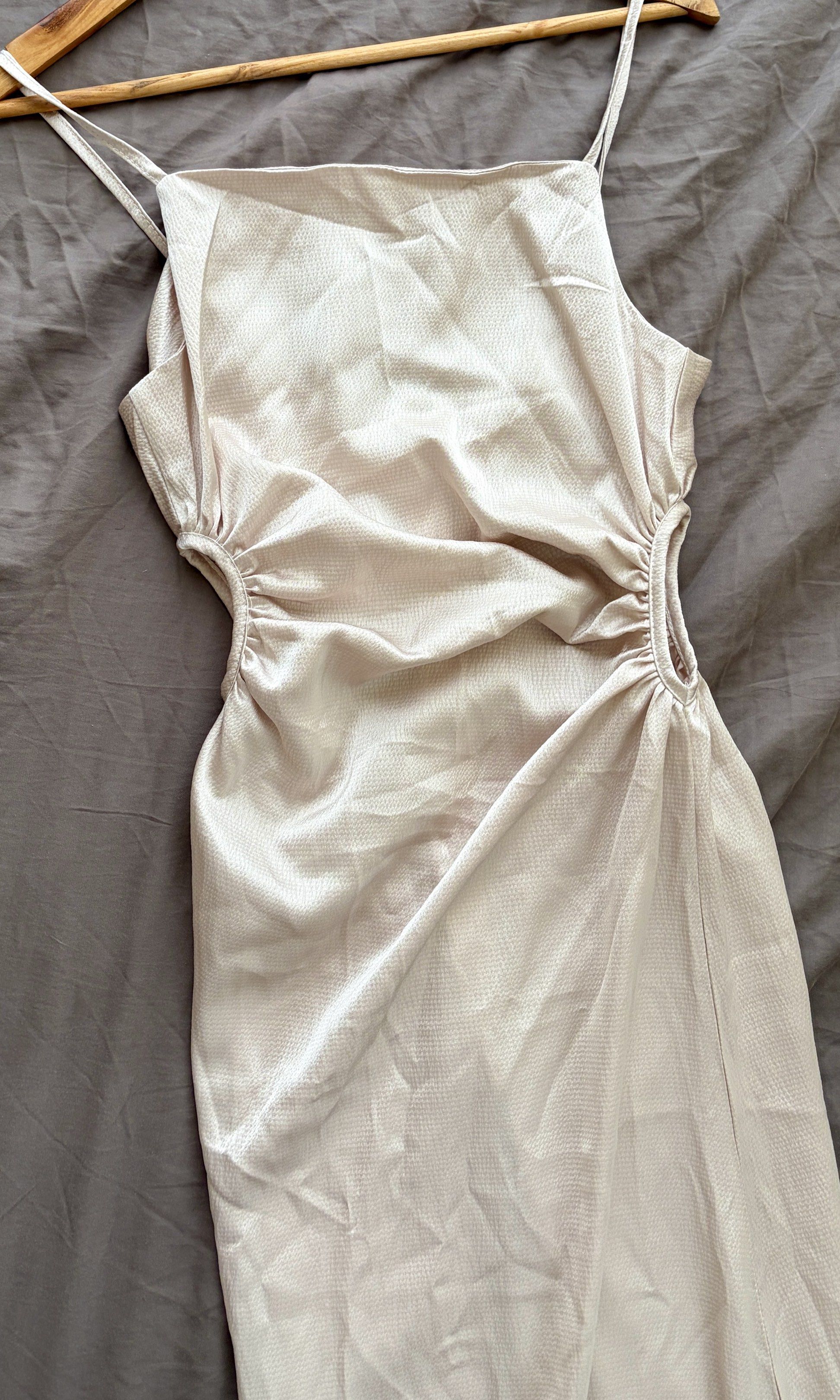 Satin Midi Dress with Cutouts (Category: Dresses) located in Makati City. Submitted by ishspace (Listing ID 1421485100, Image 2). Description: - Midi dress in a soft, neutral color - Square neckline and adjustable straps - Flattering ruching details with cutouts - Subtle sheen fabric - Ideal for special events or evenings out Fits S-M Bought from BKK pasabuy Color: beige/nude (color may differ due to lighting).