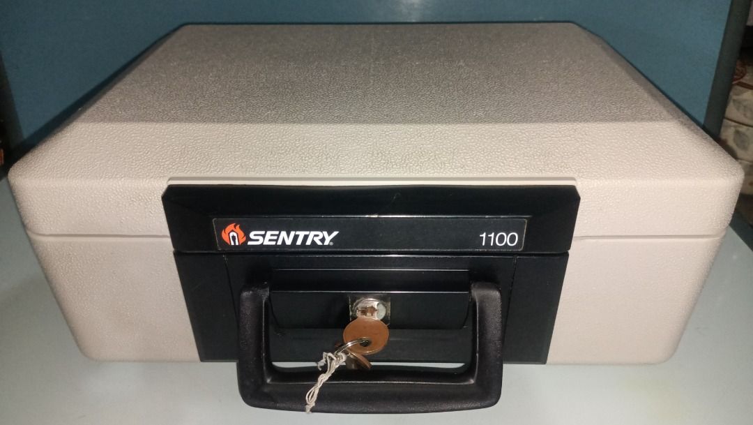 Sentry 1100 Fire Safe Box (Category: Safe) located in Munoz. Submitted by larryc1212 (Listing ID 1421577159, Image 1). Description: Sentry 1100 fire safe box. Includes keys. The safe has a black handle and lock area. The interior is light gray. The safe has a label indicating it is classified by Underwriters Laboratories Inc. as to fire resistance. The safe measures approximately 14 inches wide. Item may include some scratches due to age, as is w