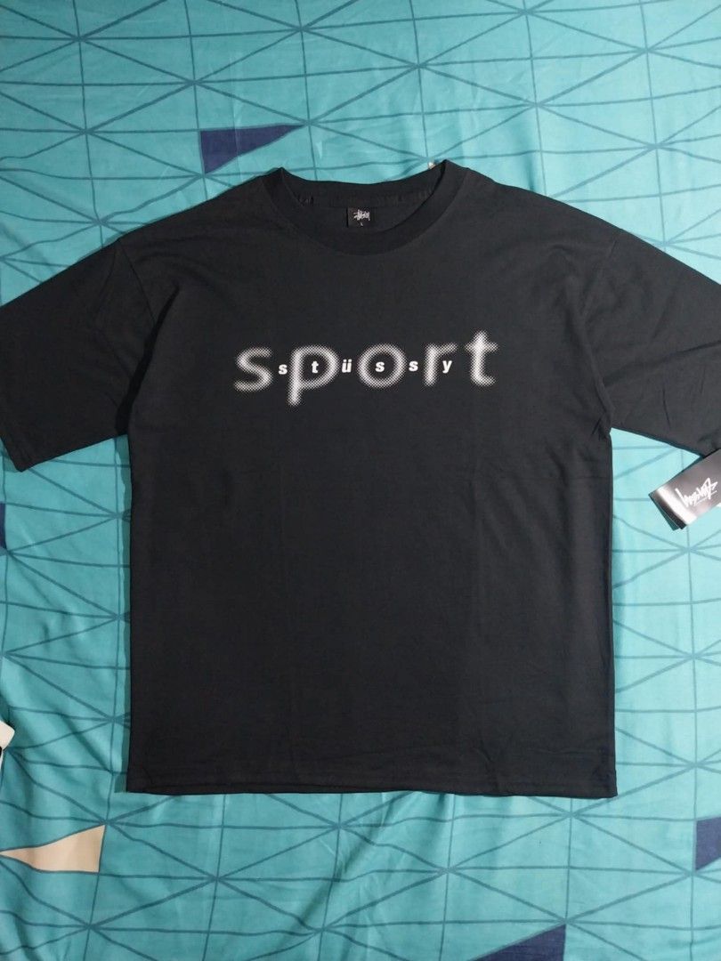 Stussy Sport Graphic Tee (Category: Tshirts & Polo Shirts ) located in Baguio. Submitted by aertssss (Listing ID 1421605530, Image 1). Description: - Black Stussy t-shirt - Features a "sport" graphic on the front - Short sleeves - Crew neck - White, stylized graphic - Black color - Brand new with tag.