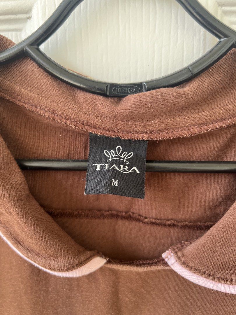 Tiara Brown Collared T-shirt - Size M (Category: Sleeveless) located in Quezon City. Submitted by millevlrd_ (Listing ID 1421509617, Image 2). Description: - Brand: Tiara - Color: Brown - Style: T-shirt with collared neckline - Collar Detail: Pink trim - Size: M.