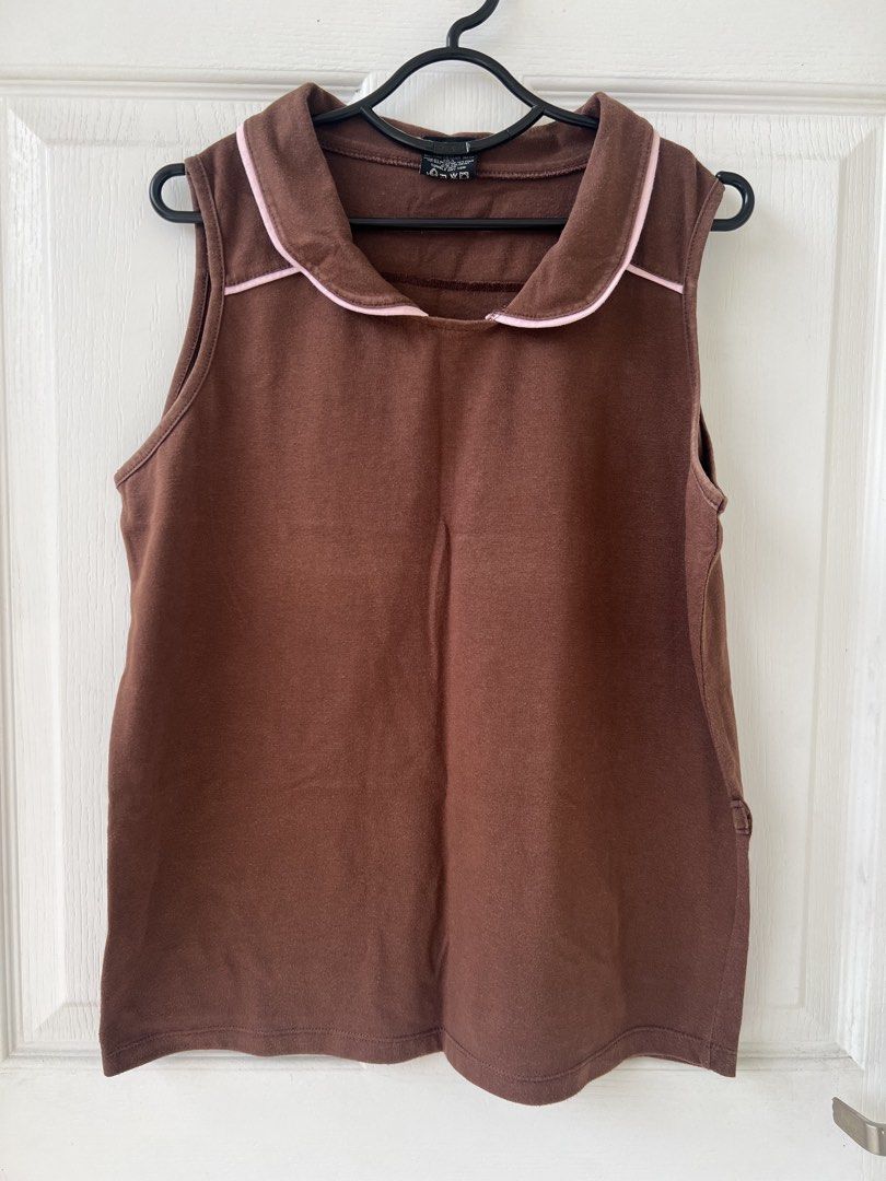 Tiara Brown Collared T-shirt - Size M (Category: Sleeveless) located in Quezon City. Submitted by millevlrd_ (Listing ID 1421509617, Image 1). Description: - Brand: Tiara - Color: Brown - Style: T-shirt with collared neckline - Collar Detail: Pink trim - Size: M.