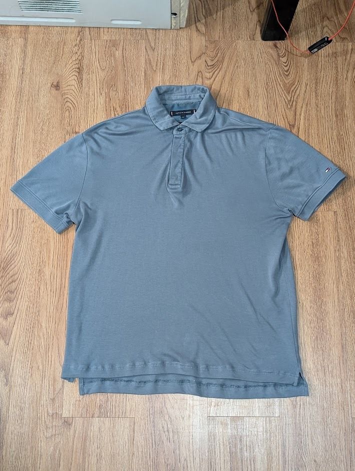 Tommy Hilfiger Polo Shirt (Category: Tshirts & Polo Shirts ) located in Manila. Submitted by fromsiah (Listing ID 1421564194, Image 2). Description: Pre-owned Tommy Hilfiger Blue Grayish Polo Shirt SIZE: Medium on tag DIMENSIONS: Width - 22.5in Length - 26.5in CONDITION: 8.5/10 ISSUE: Signs of usage, loose stitch on tag, altered Color may vary due to lighting.