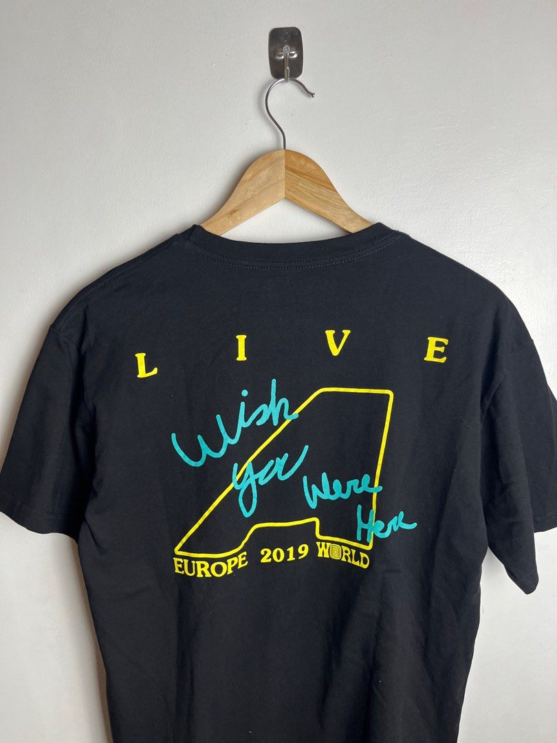 Travis Scott Astroworld Wish You Were Here Tee (Category: Tshirts & Polo Shirts ) located in Munoz. Submitted by purvyr (Listing ID 1421571190, Image 3). Description: Black Astroworld t-shirt featuring a duck graphic on the front and "Wish You Were Here" design on the back. It is a medium-sized shirt with a width of 20.5 inches and a length of 26.5 inches. The shirt is curated by Cactus Jack and made of 100% cotton. It has a crew neck and short s