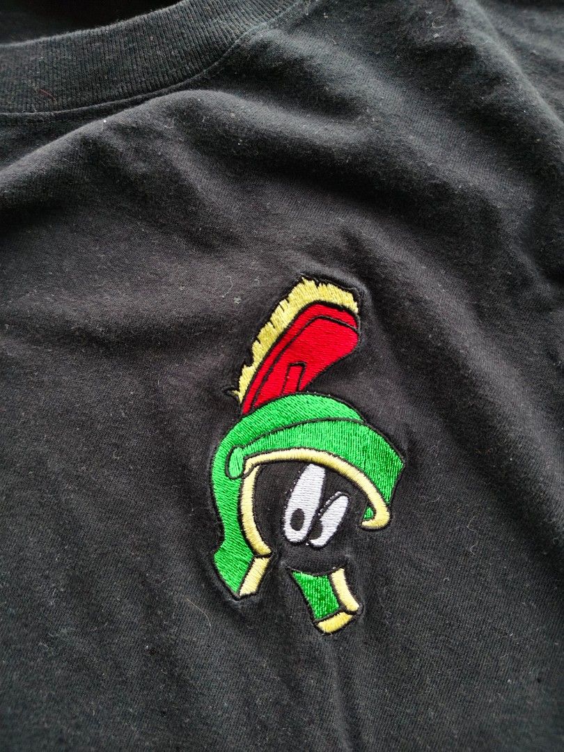Vintage Black T-shirt with Cartoon Patch (Category: Tshirts & Polo Shirts ) located in Tacloban City. Submitted by solothriftfinds (Listing ID 1421497622, Image 3). Description: - Vintage black t-shirt - Size: M - Material: Cotton - Features a cartoon patch (green and red design) - Crew neck and short sleeves - Brand tag included.