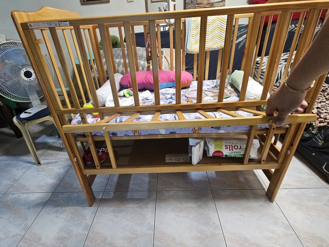 Wooden Baby Crib (Category: Cots & Cribs) located in Manila. Submitted by bigfish1990 (Listing ID 1421611929, Image 2). Description: Not the typical Baby Crib size. Bigger than the usual Crib here in PH Japan Baby Crib with storage. Bought it 16,000 without foam. Dimensions: Width 48 x Depth 31 x 44 Height Inclusions: Accessories Foam with 3 beddings Some baby Toys - Wooden baby crib with a natural finish. - Slatted design for ventilation and vis