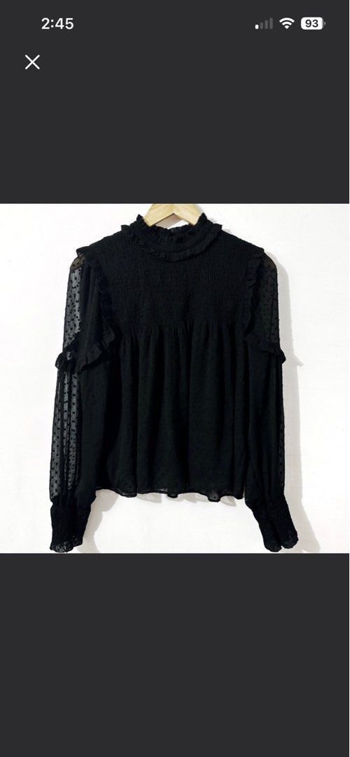 Zara Black Ruffled Blouse Elegant Classy (Category: Blouses) located in Makati City. Submitted by skippydeclutters (Listing ID 1421511449, Image 1). Description: - Black blouse with high neckline - Ruffled details - Long sleeves with sheer, dotted fabric - Textured bodice - Comfortable, flowing fit - Suitable for casual and semi-formal occasions - A versatile wardrobe addition.