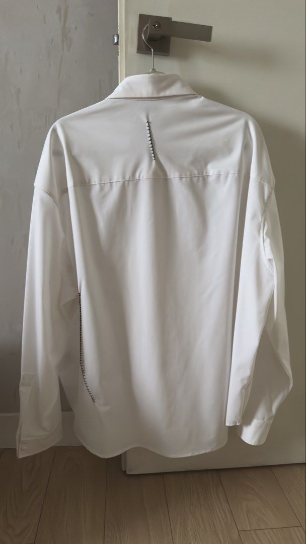 Zara White Long Sleeve Shirt (Category: Formal Shirts) located in Mandaluyong City. Submitted by olachicoas (Listing ID 1421456803, Image 2). Description: ZARA white long sleeve shirt with unique stitch detailing. • Brand: ZARA • Color: Off-white • Long sleeves • Hidden button placket (clean front look) • Minimalist black stitch accents (front, back & side) • Relaxed / slightly oversized fit • Smooth structured fabric Very classy and modern piece