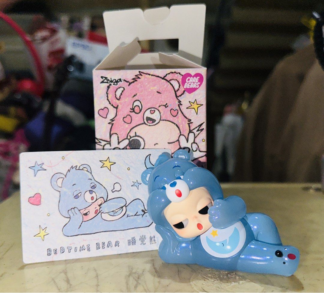 Zsiga Care Bears Time Bear Popmart (Category: Designer & Blind Box Toys) located in Manila. Submitted by hannatewakuso (Listing ID 1421547760, Image 2). Description: - Ziga Care Bears Time Bear figure - Features a blue bear design - Includes original box and collectible card - Purchased from Filbar’s One Ayala today (02.14) RFS: I dont like it, lol it was an impulse buy Ships from Metro Manila.