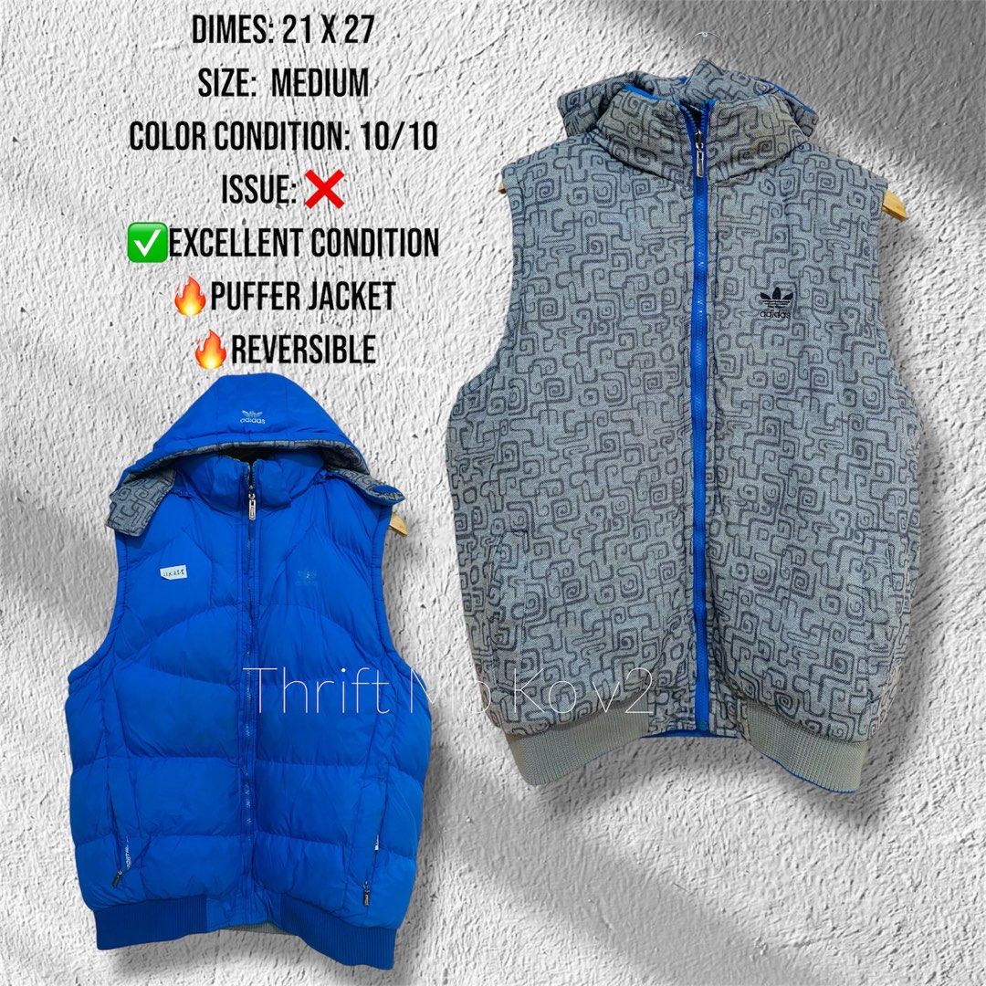 Adidas Reversible Puffer Vest Medium (Category: Vests) located in Santiago. Submitted by mfdthriftstore (Listing ID 1421686756, Image 1). Description: - Adidas reversible puffer vest - Size: Medium - Colors: Blue (exterior) / Grey patterned (interior) - Features: Hood, full-length zipper - Adidas logo on chest and hood - Condition: Excellent.