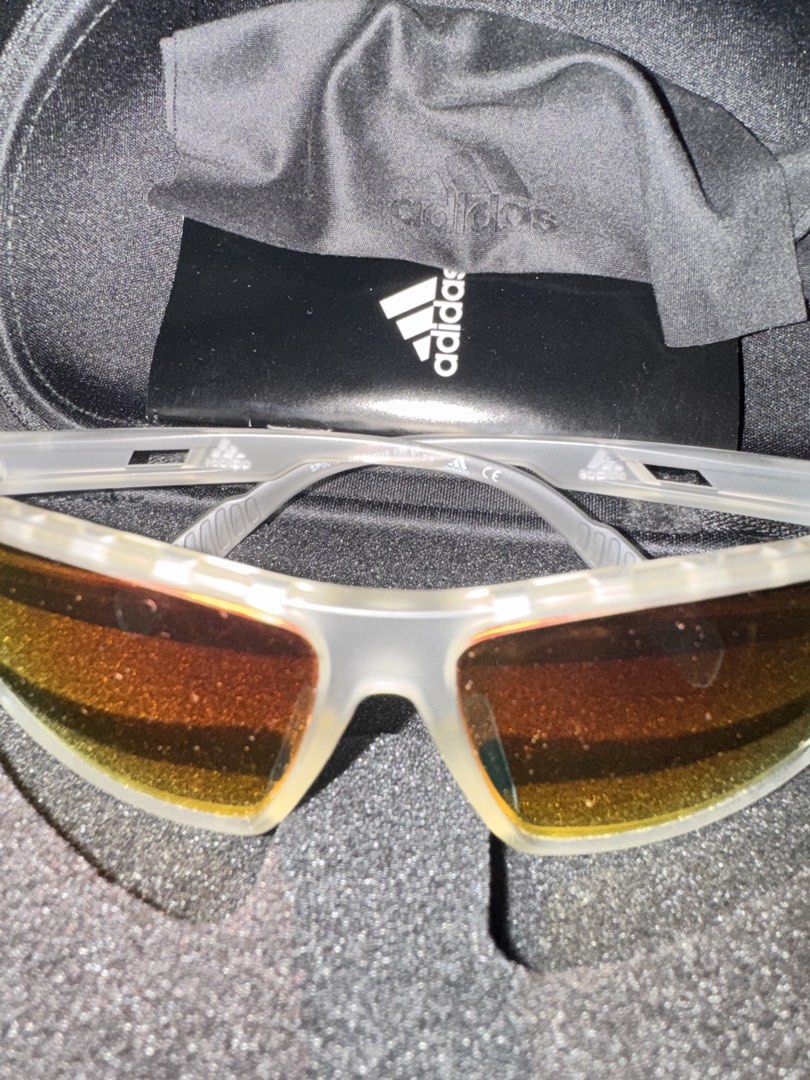 Adidas SP0010 Sunglasses Orange/White (Category: Sunglasses & Eyewear) located in Quezon City. Submitted by kentivan21 (Listing ID 1421681369, Image 1). Description: - Adidas sunglasses - Clear frame - Orange-tinted lenses - Includes Adidas case (hard shell) and cleaning cloth.
