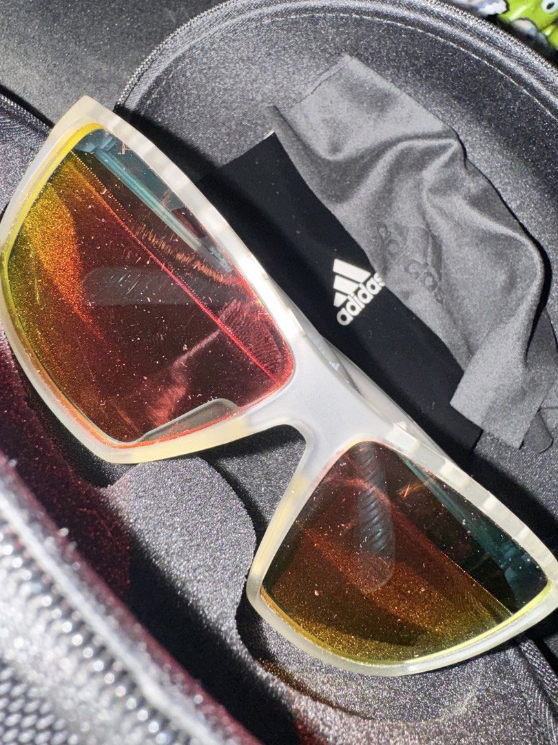Adidas SP0010 Sunglasses Orange/White (Category: Sunglasses & Eyewear) located in Quezon City. Submitted by kentivan21 (Listing ID 1421681369, Image 2). Description: - Adidas sunglasses - Clear frame - Orange-tinted lenses - Includes Adidas case (hard shell) and cleaning cloth.