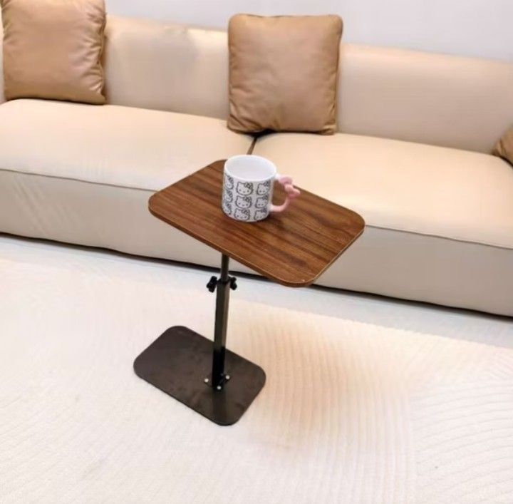 Adjustable Height Side Table (Category: Tables & Sets) located in Manila. Submitted by micoooy (Listing ID 1421644249, Image 2). Description: - Adjustable height (53-80cm) - Rectangular wooden tabletop - Sturdy black base - Easy height adjustment - Great for books, drinks, and more - Ideal for sofa or bed use.