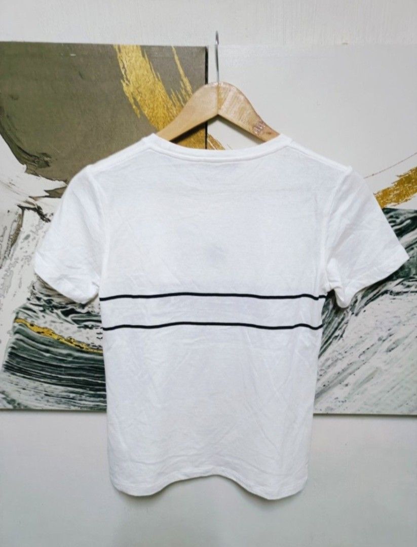AUTHENTIC CHRISTIAN DIOR T SHIRT (Category: Luxury Apparel) located in Arayat. Submitted by angels_closet247 (Listing ID 1421699709, Image 3). Description: - Authentic Christian Dior T-shirt - Features a white base with a black star logo - Brand name across the chest - Made in Italy - Size: S Actual size using inches Armpit to Armpit 17 Lenght /23 fittings is Small Excellent Condition, Issue: 😉Message if you have any other question about sizing.