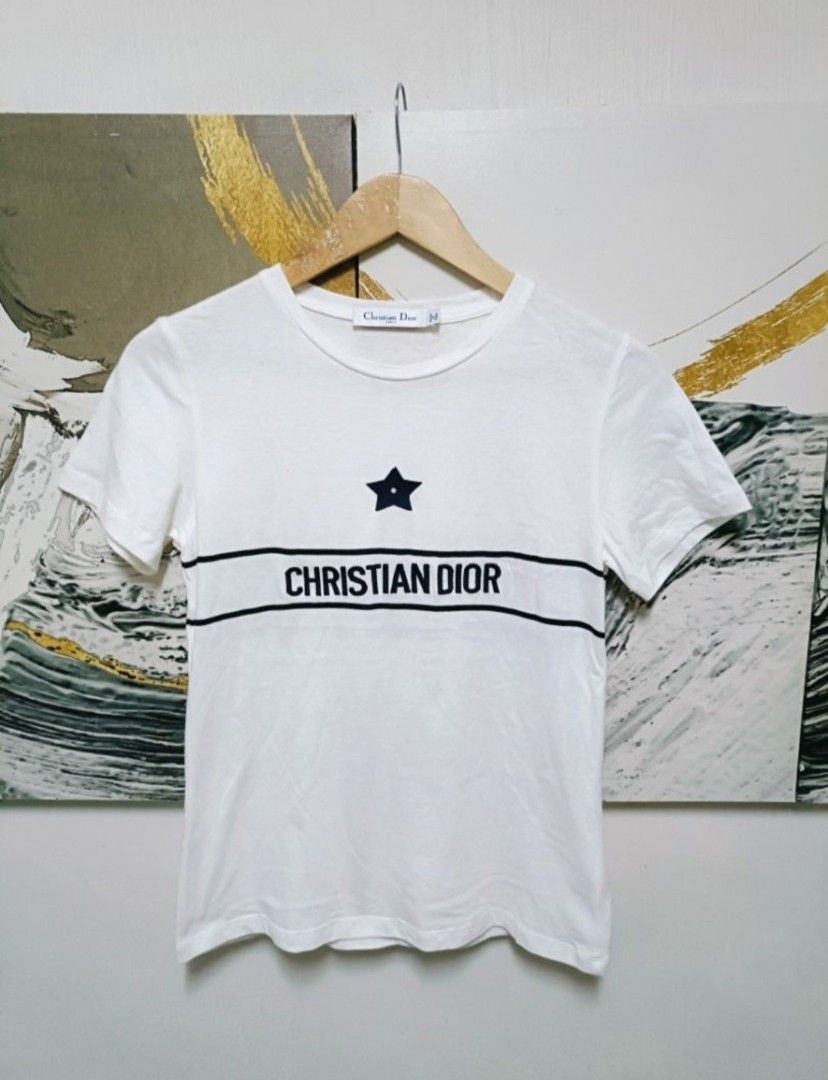 AUTHENTIC CHRISTIAN DIOR T SHIRT (Category: Luxury Apparel) located in Arayat. Submitted by angels_closet247 (Listing ID 1421699709, Image 2). Description: - Authentic Christian Dior T-shirt - Features a white base with a black star logo - Brand name across the chest - Made in Italy - Size: S Actual size using inches Armpit to Armpit 17 Lenght /23 fittings is Small Excellent Condition, Issue: 😉Message if you have any other question about sizing.