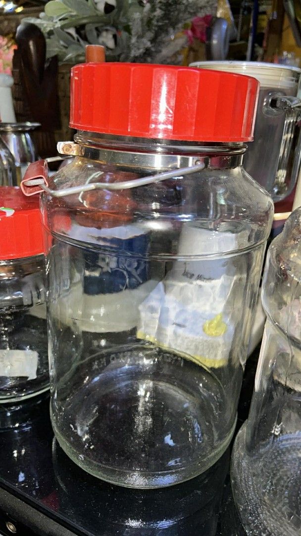 BIG IMPORTED CLEAR GLASS JARS W/ LIDS (Category: Food Organization & Storage) located in Valenzuela. Submitted by gregferraren (Listing ID 1421741841, Image 3). Description: big glass jars with red lids. Various sizes available, perfect for storage or display. Some jars have ribbed designs, while others are smooth. One jar has a metal clasp. Great for kitchen organization or as decorative pieces. These jars are sturdy and well-made, offering a cl