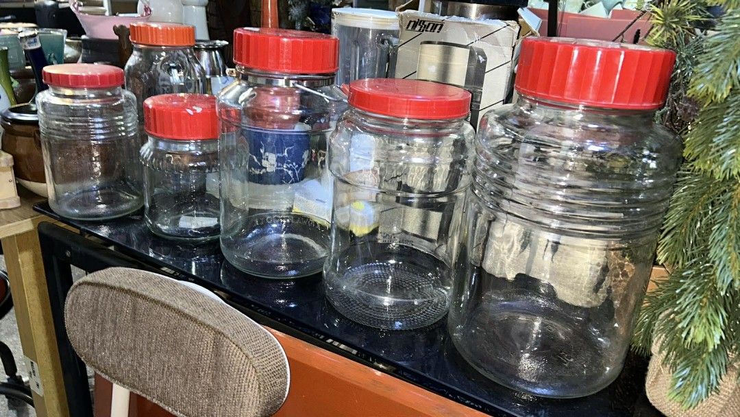 BIG IMPORTED CLEAR GLASS JARS W/ LIDS (Category: Food Organization & Storage) located in Valenzuela. Submitted by gregferraren (Listing ID 1421741841, Image 1). Description: big glass jars with red lids. Various sizes available, perfect for storage or display. Some jars have ribbed designs, while others are smooth. One jar has a metal clasp. Great for kitchen organization or as decorative pieces. These jars are sturdy and well-made, offering a cl