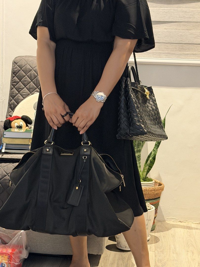 Michael Kors Travel Black Handbag (Category: Luxury Bags & Wallets) located in Rizal. Submitted by bubblesnow (Listing ID 1421724606, Image 2). Description: - Black handbag good for overnight bag, or handcarry travel bag. - Unique shape - Zipper closure - Made of a nylon-like material - partially negotiable .