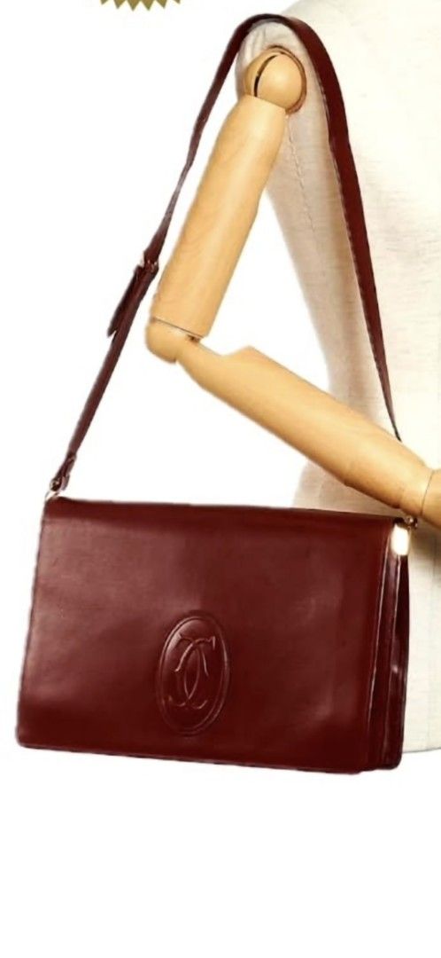 Cartier Shoulder Bag (Category: Luxury Bags & Wallets) located in Quezon City. Submitted by cncarousel (Listing ID 1421695529, Image 2). Description: - Authentic Cartier shoulder bag - Rich burgundy color - Classic design with Cartier logo - Adjustable shoulder strap - Gold-tone hardware - Spacious interior with small pocket - Perfect for everyday or special events compared with 2x,000.