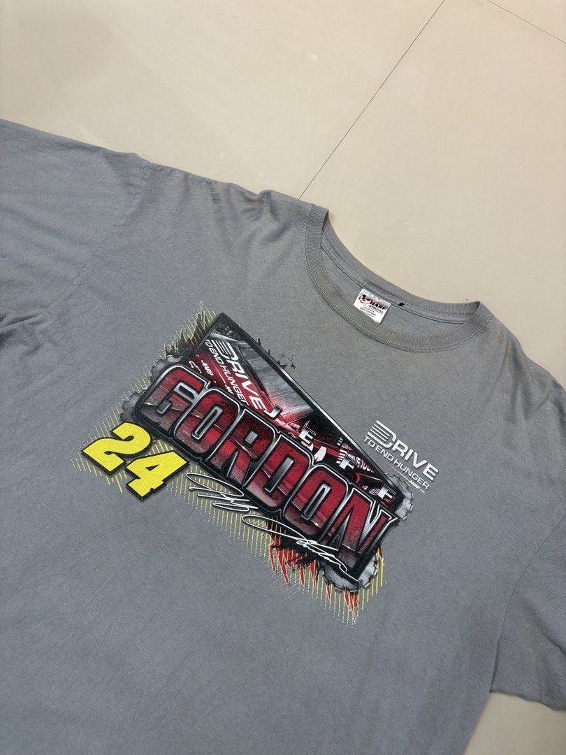 Chase Authentics Jeff Gordon #24 T-Shirt (Category: Tshirts & Polo Shirts ) located in Lipa City. Submitted by thriftopia_sj (Listing ID 1421659872, Image 2). Description: - Jeff Gordon #24 t-shirt - Gray color - Front design: "GORDON" and "24" with racing graphic - Back design: Red and black race car - Chase Authentics tag - Material: 100% cotton Dimes 27x32 Flaws : Stains (not sure if washable).