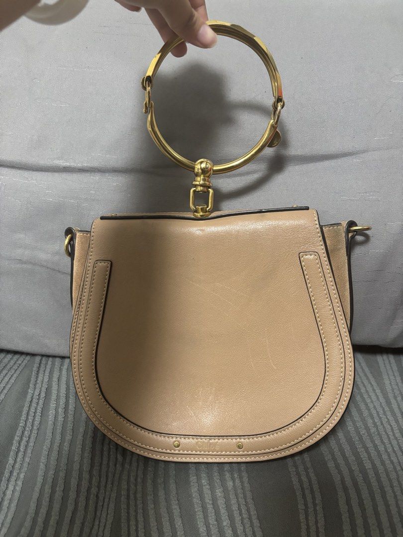 Chloe Nile Bracelet Bag (Category: Luxury Bags & Wallets) located in Quezon City. Submitted by castrob21 (Listing ID 1421672893, Image 2). Description: - Chloe Nile Bracelet Bag - Color: Beige - Distinctive gold-tone bracelet handle - Detachable shoulder strap - Flap closure - Spacious interior with slip pocket - Made in Italy - Includes serial number and brand markings Flaws - some scratches due to hardware - signs of tarnishing on the hardware 