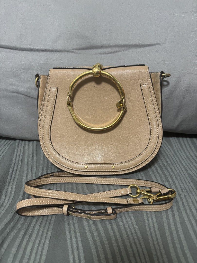 Chloe Nile Bracelet Bag (Category: Luxury Bags & Wallets) located in Quezon City. Submitted by castrob21 (Listing ID 1421672893, Image 1). Description: - Chloe Nile Bracelet Bag - Color: Beige - Distinctive gold-tone bracelet handle - Detachable shoulder strap - Flap closure - Spacious interior with slip pocket - Made in Italy - Includes serial number and brand markings Flaws - some scratches due to hardware - signs of tarnishing on the hardware 