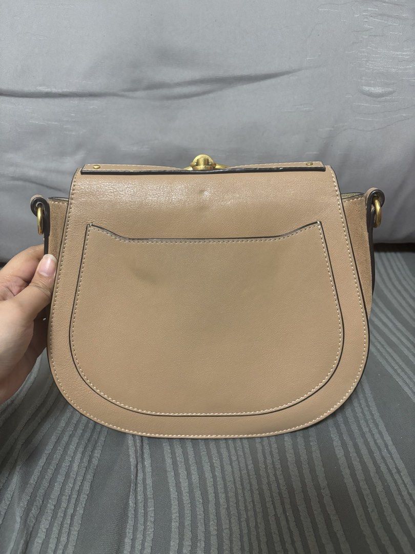 Chloe Nile Bracelet Bag (Category: Luxury Bags & Wallets) located in Quezon City. Submitted by castrob21 (Listing ID 1421672893, Image 3). Description: - Chloe Nile Bracelet Bag - Color: Beige - Distinctive gold-tone bracelet handle - Detachable shoulder strap - Flap closure - Spacious interior with slip pocket - Made in Italy - Includes serial number and brand markings Flaws - some scratches due to hardware - signs of tarnishing on the hardware 
