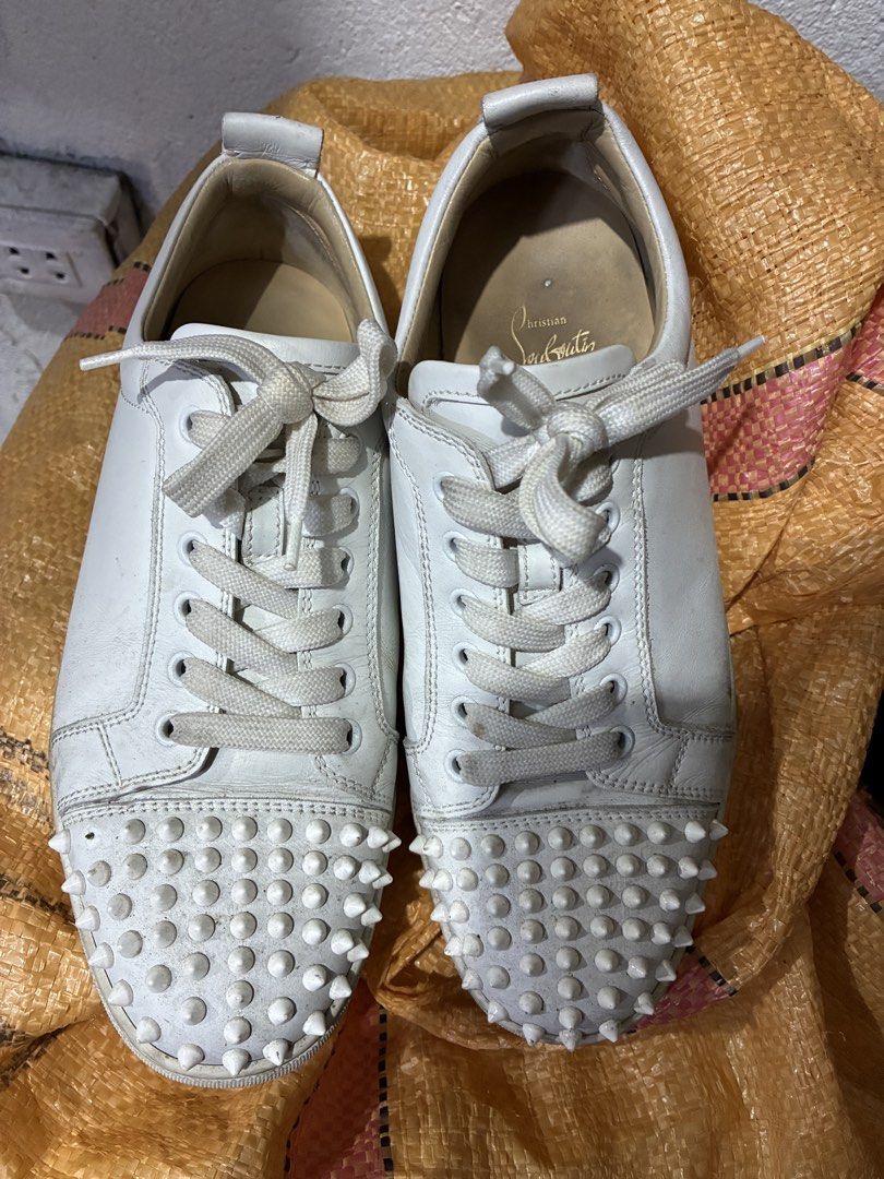 Christian Louboutin White Spiked Sneakers (Category: Sneakers) located in Placer. Submitted by talaalond61563 (Listing ID 1421723749, Image 1). Description: - Christian Louboutin sneakers - White color with spiked toe caps - Size: 41 - Made in EU - Signature red soles - White laces - Brand name visible on insole.