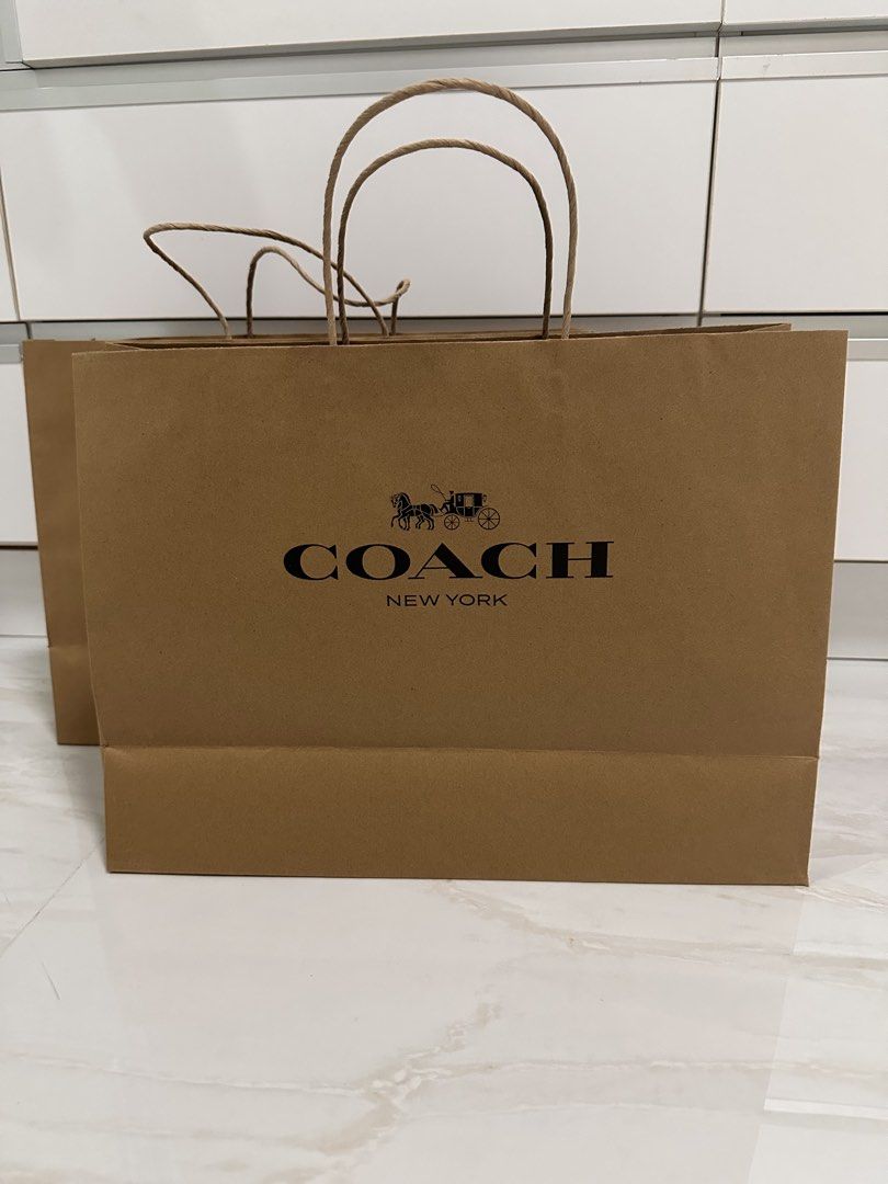 Coach Paper Bag (Category: Luxury Bags & Wallets) located in Taytay. Submitted by alyza2closet (Listing ID 1421619633, Image 1). Description: - Authentic Coach paper bag - Features Coach logo and horse and carriage design - Includes brown paper handles - Perfect for gifting or collecting.