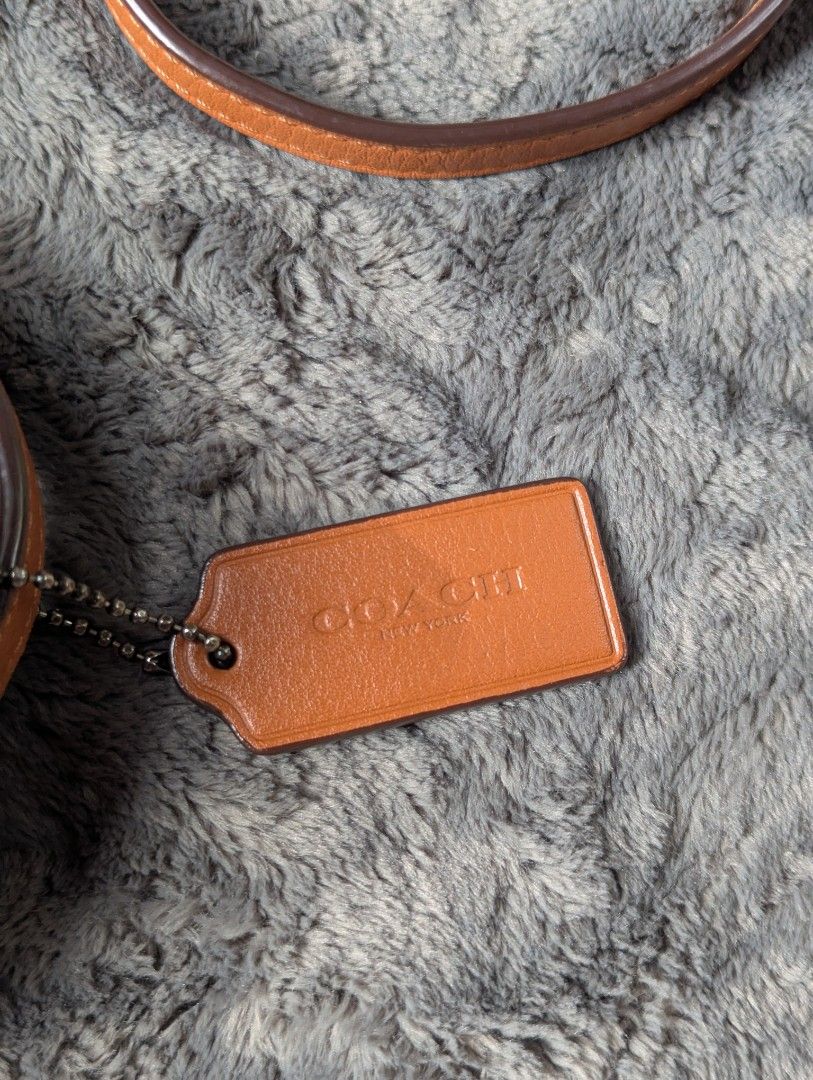 Coach Saddle Crossbody Bag (Category: Luxury Bags & Wallets) located in Manila. Submitted by eladp (Listing ID 1421730035, Image 2). Description: - Authentic Coach crossbody bag -Preloved RETAIL item - Saddle bag design - Tan leather exterior - Adjustable strap - Magnetic snap closure - Includes Coach hangtag - Interior zippered pocket - Additional slip pocket.