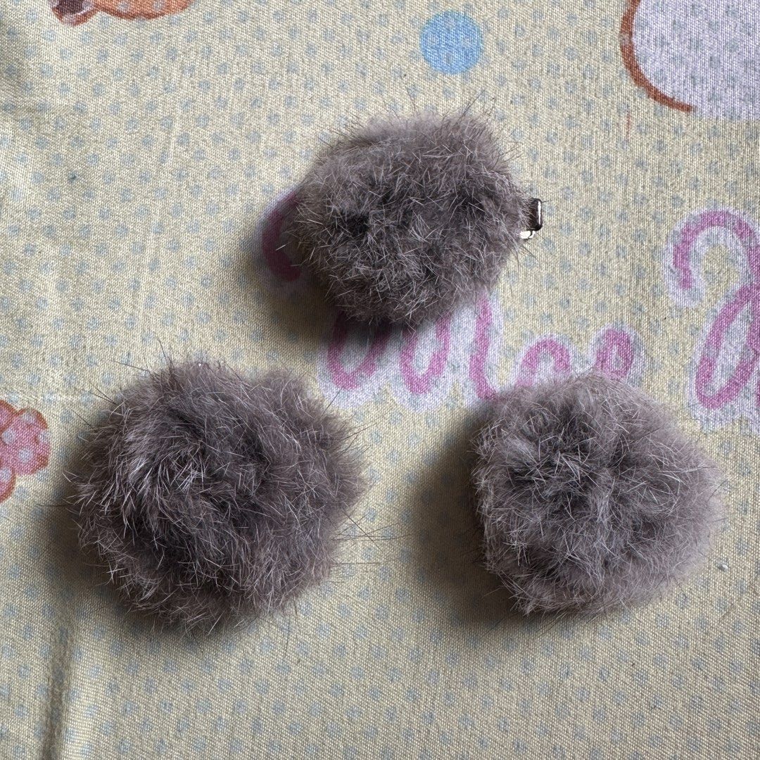 Fluffy Hair Clips (Category: Hair Accessories) located in Quezon City. Submitted by purinluver (Listing ID 1421656588, Image 1). Description: - Set of 3 fluffy hair clips - Round, furry gray balls - Small metal clips for easy attachment - Simple and cute hair accessory.