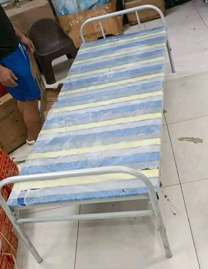 Folding Bed with Mattress (Category: Bed Frames & Mattresses) located in Makati City. Submitted by oideme (Listing ID 1421643457, Image 2). Description: - Folding bed with a striped mattress - Features a white metal frame - Easily foldable for compact storage - Ideal space-saving solution - Great for guests or small living areas - Comes with original packaging.