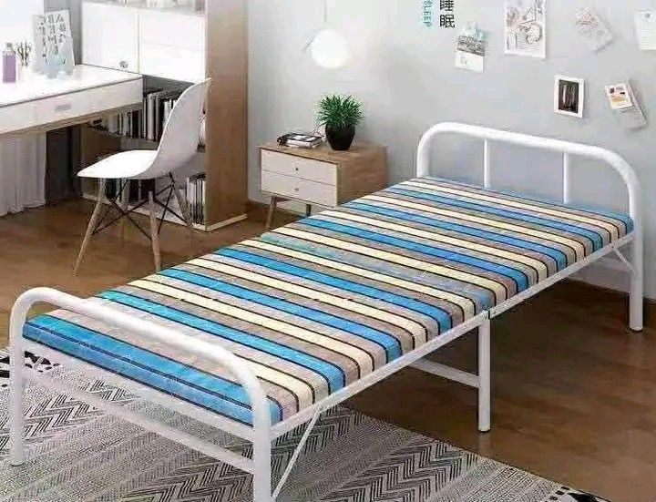 Folding Bed with Mattress (Category: Bed Frames & Mattresses) located in Makati City. Submitted by oideme (Listing ID 1421643457, Image 1). Description: - Folding bed with a striped mattress - Features a white metal frame - Easily foldable for compact storage - Ideal space-saving solution - Great for guests or small living areas - Comes with original packaging.