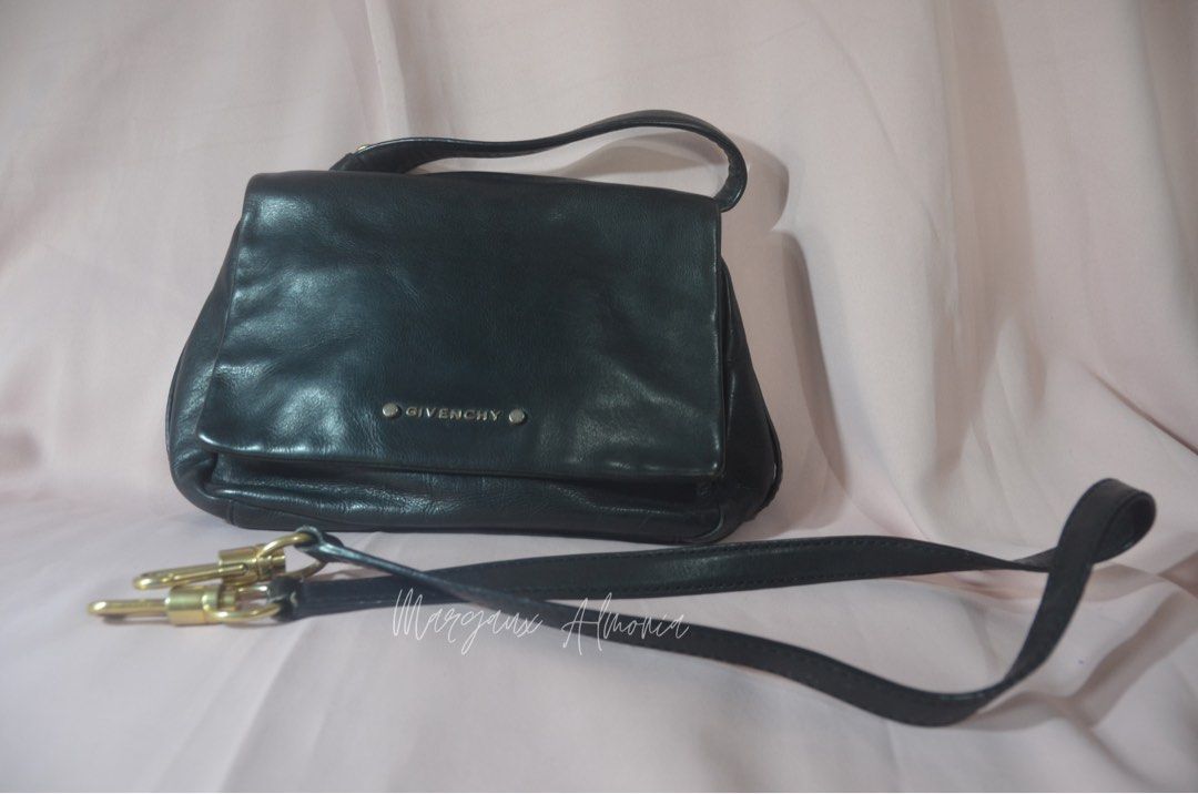 Givenchy Black Leather Handbag (Category: Luxury Bags & Wallets) located in Paranaque City. Submitted by margauxjc39954 (Listing ID 1421755441, Image 1). Description: - Givenchy black leather handbag - Top handle and detachable shoulder strap - Flap closure with Givenchy logo - Single interior compartment - Gold-toned hardware - Classic, structured design.