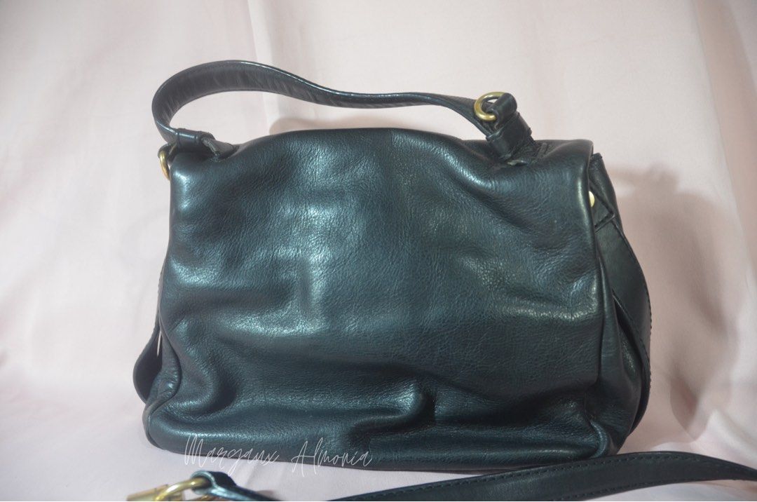 Givenchy Black Leather Handbag (Category: Luxury Bags & Wallets) located in Paranaque City. Submitted by margauxjc39954 (Listing ID 1421755441, Image 2). Description: - Givenchy black leather handbag - Top handle and detachable shoulder strap - Flap closure with Givenchy logo - Single interior compartment - Gold-toned hardware - Classic, structured design.